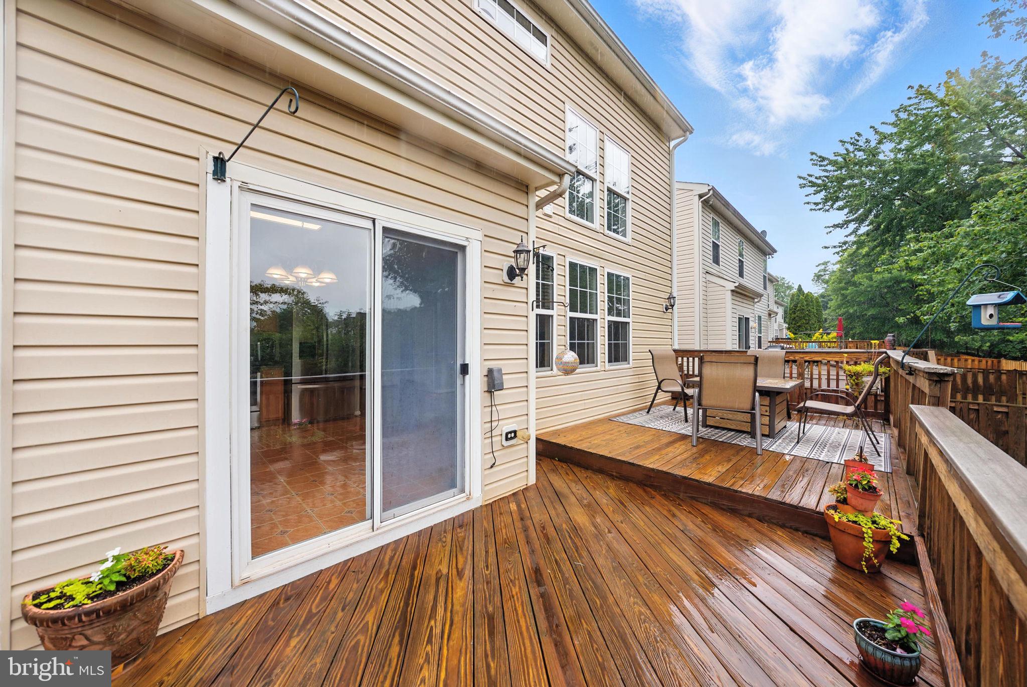 14387 Newbern Loop Gainesville, VA 20155 - Photo 32 of 38 a view of a balcony with chairs and wooden floor