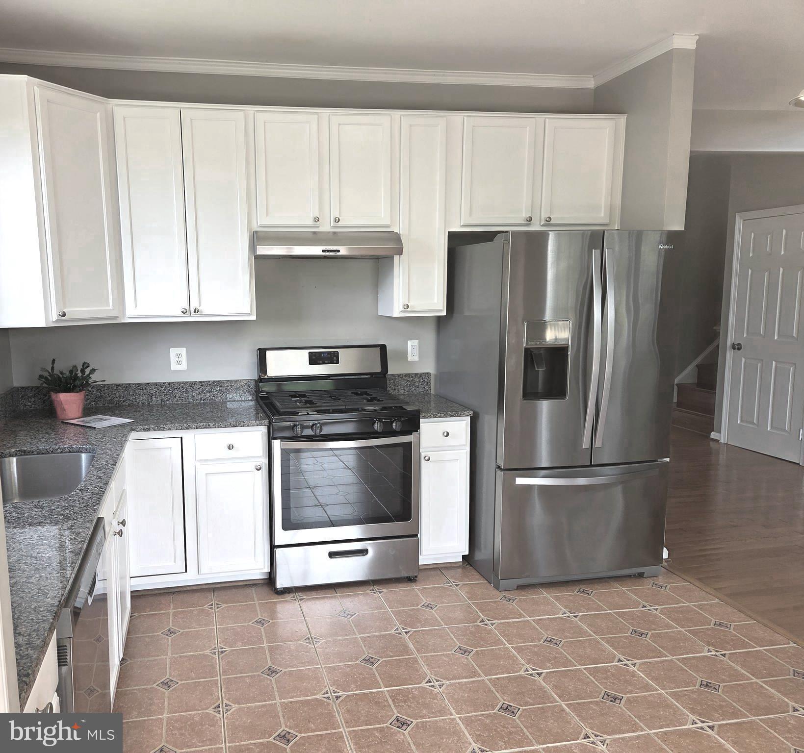 14387 Newbern Loop Gainesville, VA 20155 - Photo 9 of 38 a kitchen with a refrigerator sink and microwave