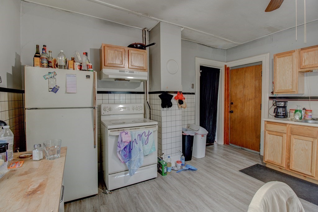 339 Front Street Chicopee, MA 01013 - Photo 11 of 22 a kitchen with a refrigerator and white cabinets