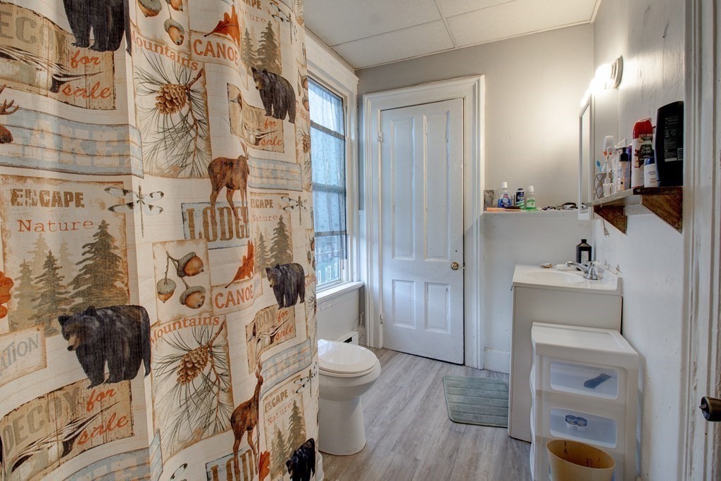 339 Front Street Chicopee, MA 01013 - Photo 12 of 22 a bathroom with a sink and mirror with toilet