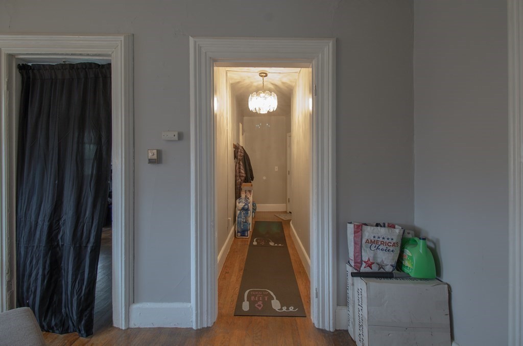 339 Front Street Chicopee, MA 01013 - Photo 16 of 22 a view of a hallway with room wooden floor and a livingroom view