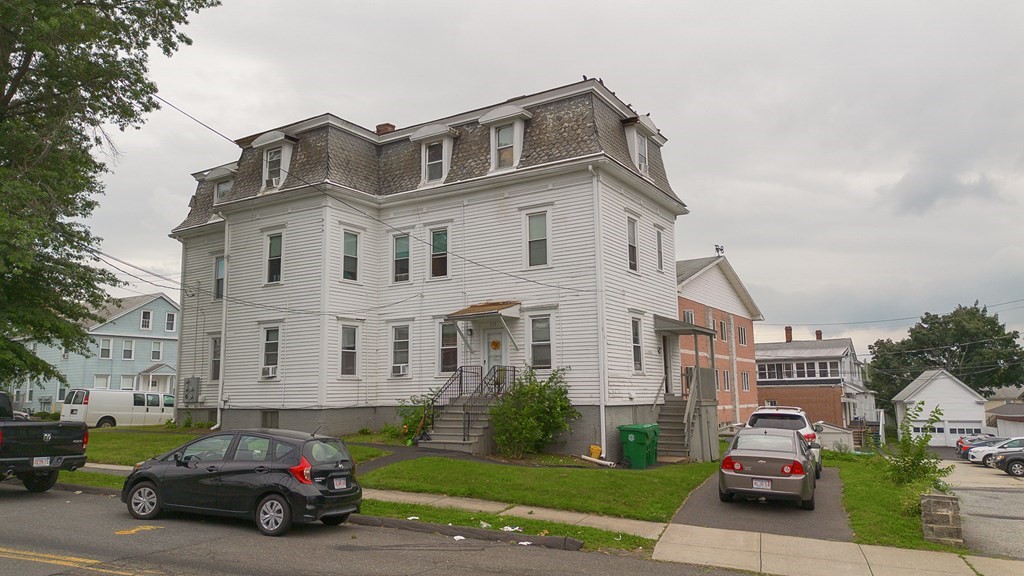 339 Front Street Chicopee, MA 01013 - Photo 2 of 22 a car parked in front of a white house