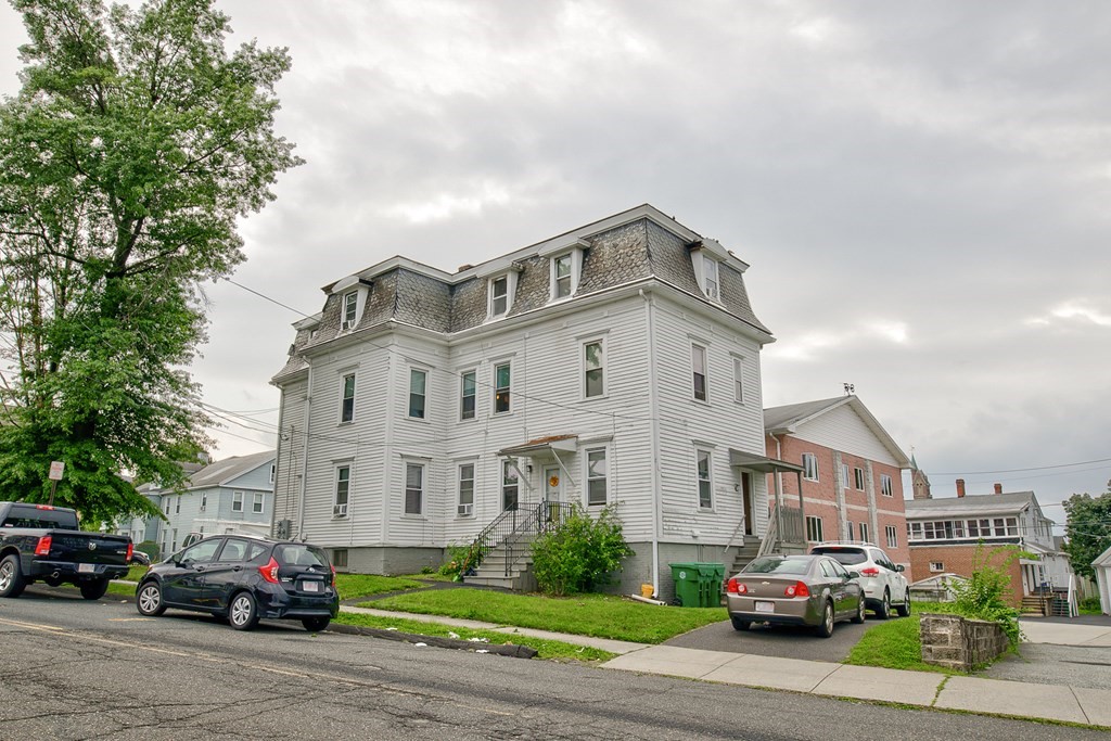 339 Front Street Chicopee, MA 01013 - Photo 7 of 22 a front view of a building with cars parked