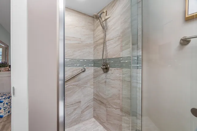 a bathroom with a glass shower door