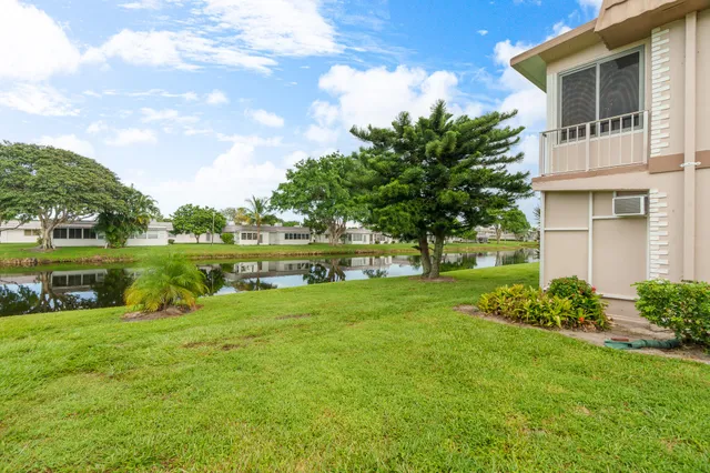 a view of a house with a yard and a fountain