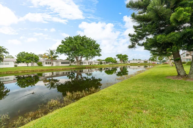 a view of a lake with houses in the back