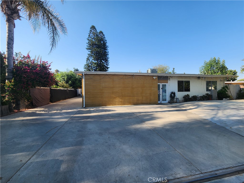 a view of a house with a yard and a garage