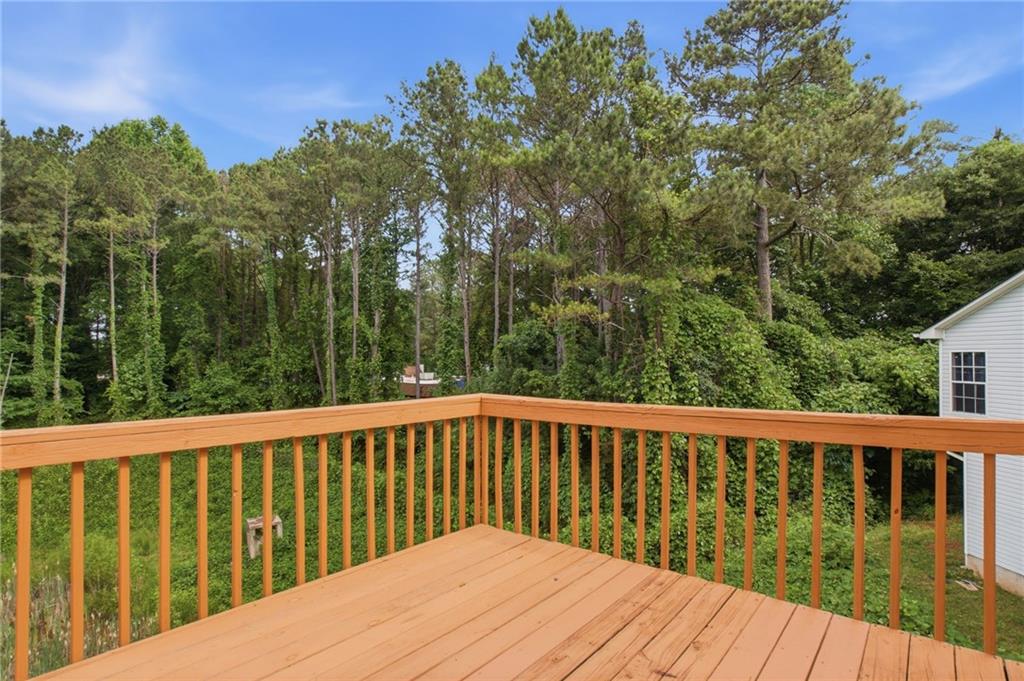 5855 Crescent Ridge Court Lithonia, GA 30058 - Photo 40 of 46 a balcony with wooden floor and trees in the background