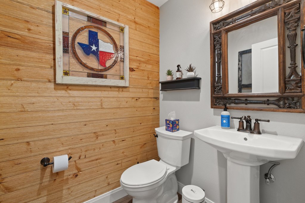 23644 Nameless Road Leander, TX 78641 - Photo 11 of 40 Wood plank accent walls and an ornate framed mirror highlight this bathroom's distinctive character.