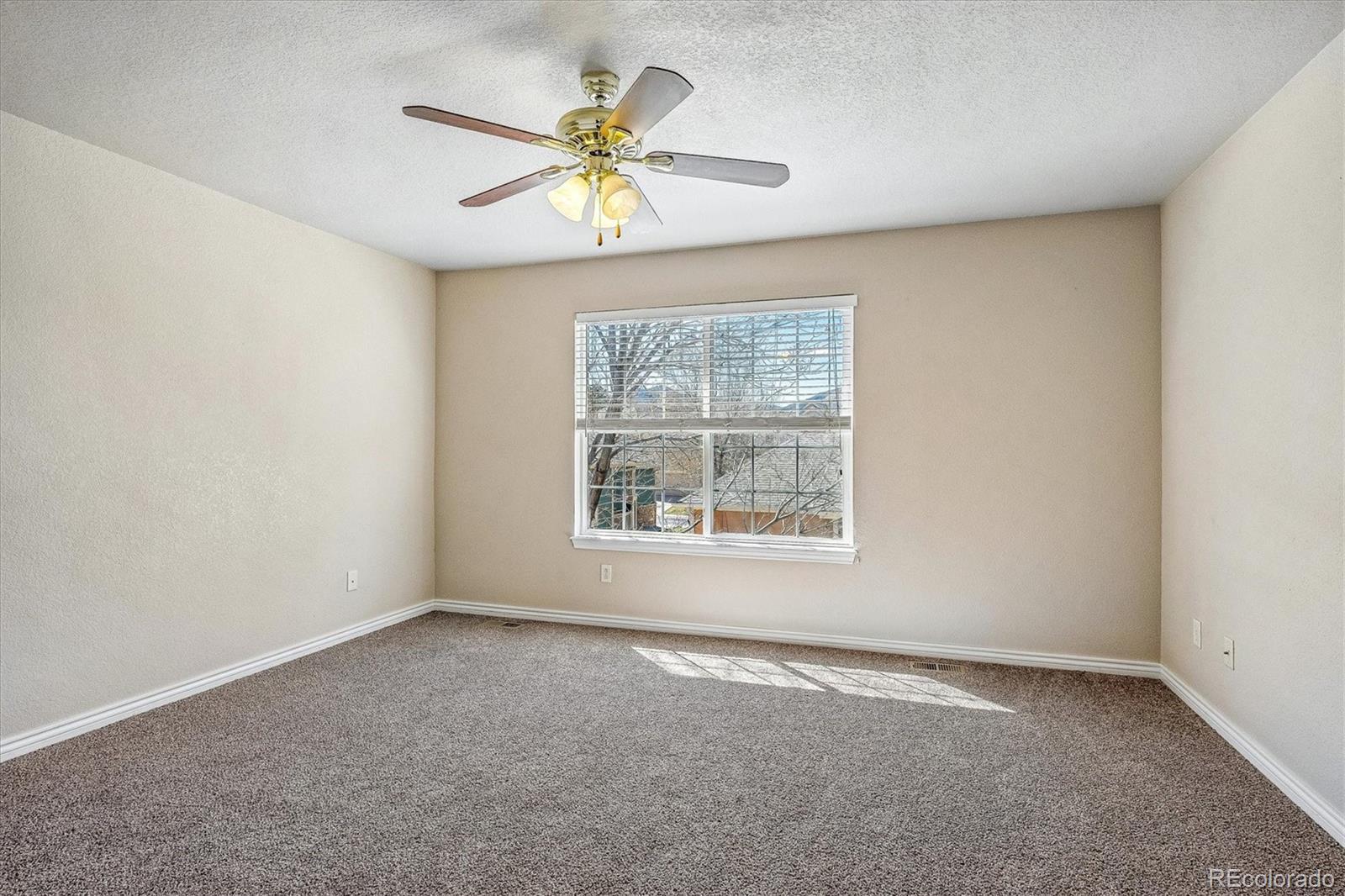 4545 South Taft Way Morrison, CO 80465 - Photo 18 of 24 an empty room with a window and a fan