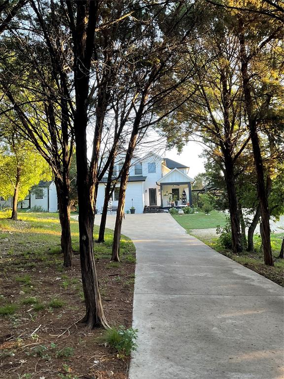 4920 Shining Star Trail Rio Vista, TX 76093 - Photo 3 of 39 a front view of a house with a yard and an trees
