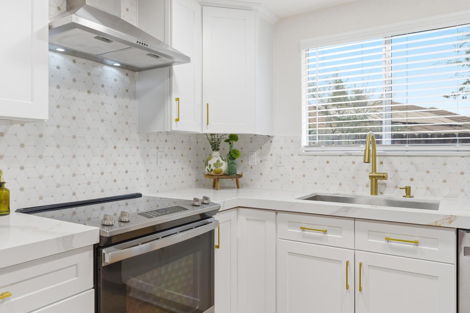 1671 Davis Street Ripon, CA 95366 - Photo 16 of 40 a kitchen with a sink stove and cabinets