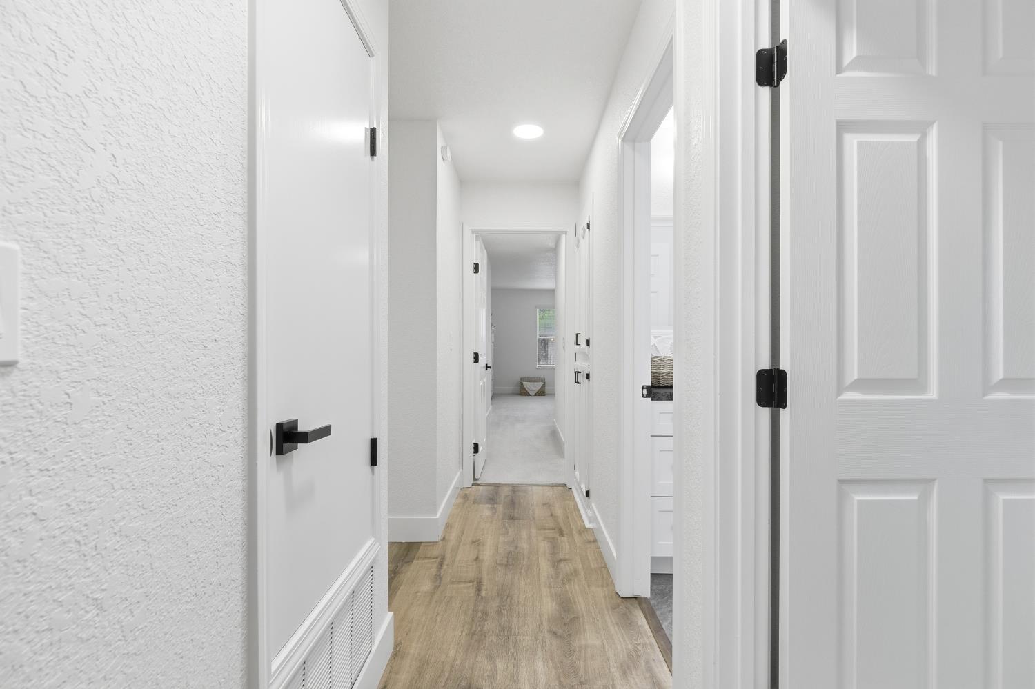 1671 Davis Street Ripon, CA 95366 - Photo 19 of 40 a view of a hallway with wooden floor and staircase