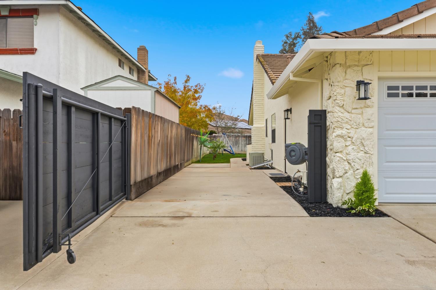 1671 Davis Street Ripon, CA 95366 - Photo 6 of 40 a view of a white house with large windows