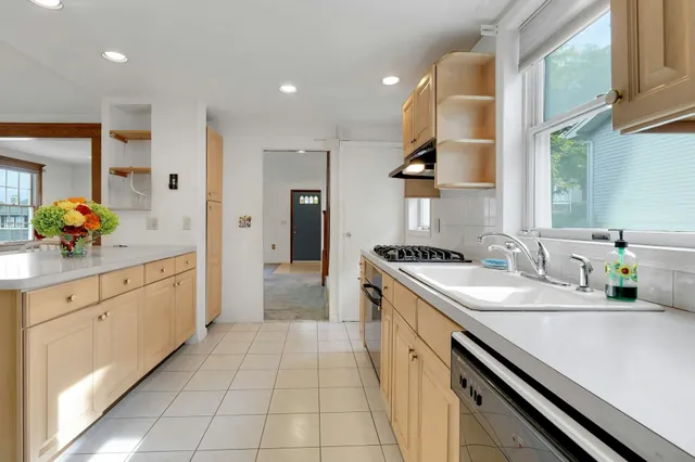 a large kitchen with a sink and cabinets