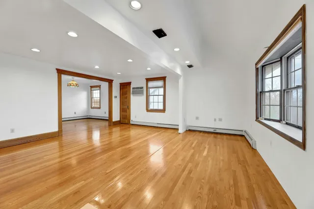 a view of a livingroom with wooden floor and window