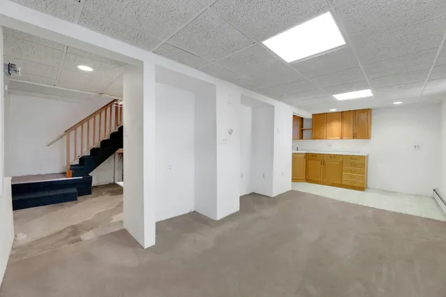 a view of an empty room with a fireplace and a window