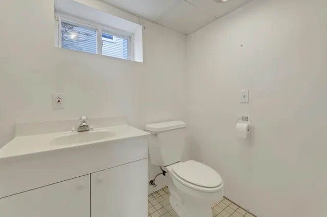 a white toilet sitting next to a white sink
