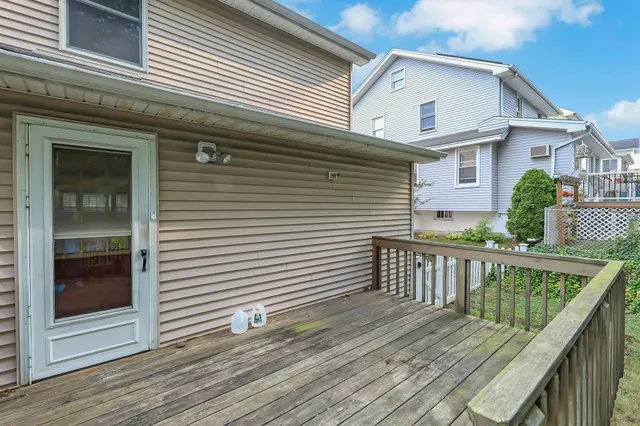 a view of a house with wooden deck