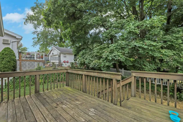 a balcony with wooden floor and fence