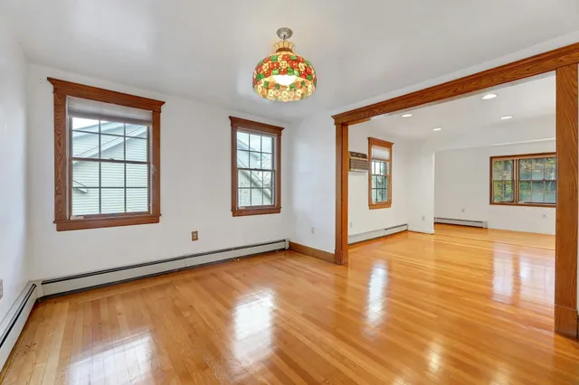 a view of an entryway with wooden floor and windows