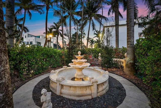 a view of a fountain in the backyard of house