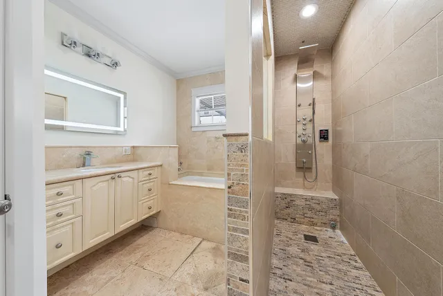 a spacious bathroom with a shower sink and mirror