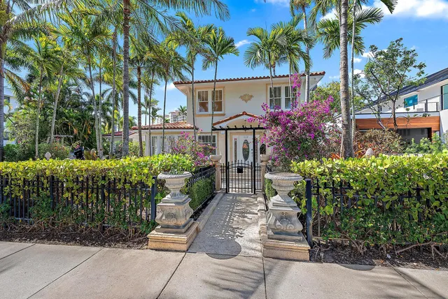 a front view of a house with a garden