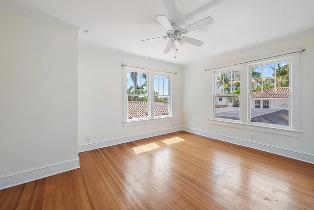 wooden floor in an empty room with a window