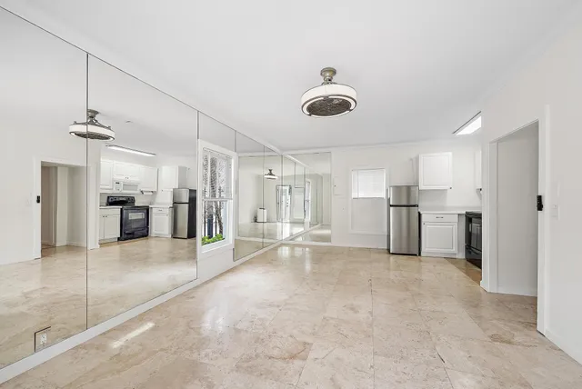 a view of a kitchen with a sink and cabinets