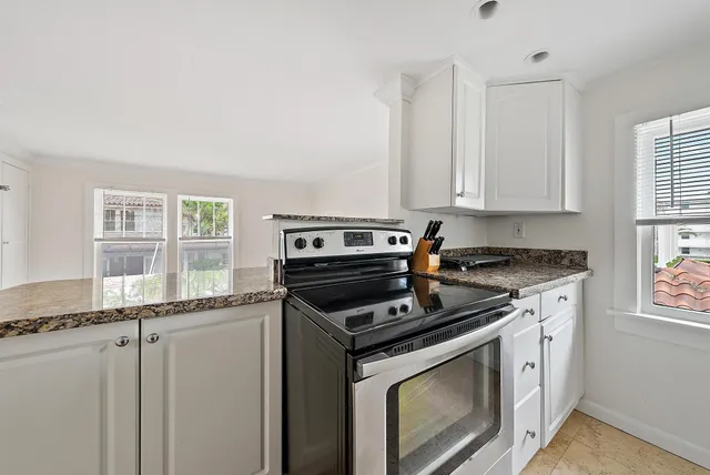 a kitchen with stainless steel appliances granite countertop a stove and a microwave