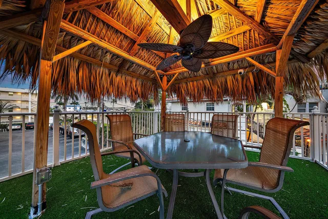 a backyard of a house with table and chairs