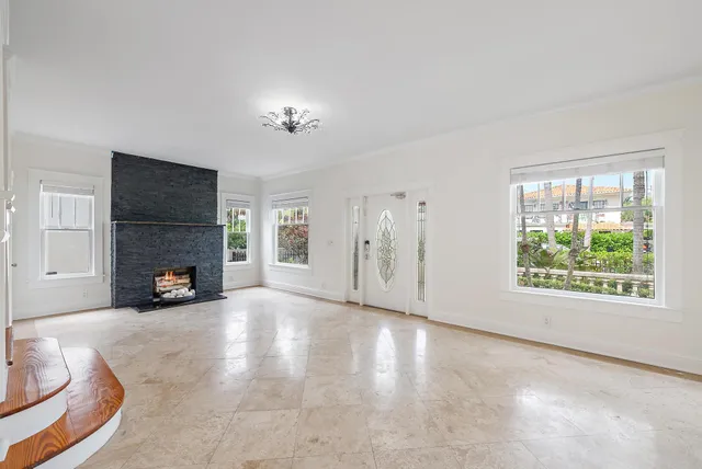 a view of an empty room with a fireplace and a window