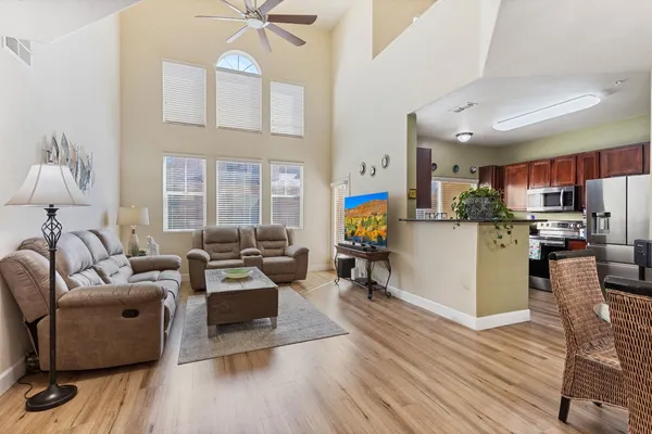 a living room with furniture and a wooden floor