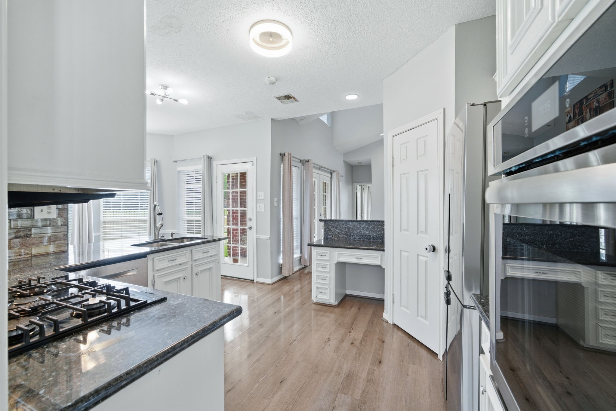14519 Sandalfoot Street Houston, TX 77095 - Photo 11 of 41 a kitchen with stainless steel appliances granite countertop a stove and a wooden floors