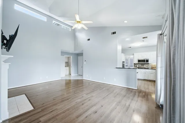 a view of a kitchen with a sink and a refrigerator