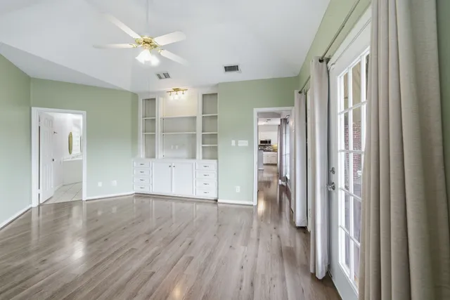 wooden floor in an empty room with a window