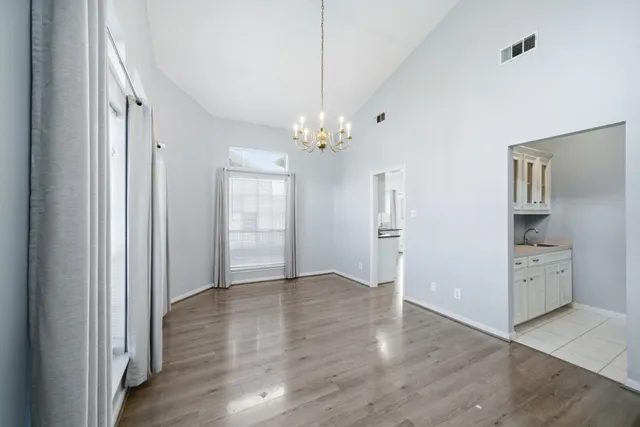 a view of a kitchen with a dishwasher cabinets and a wooden floor