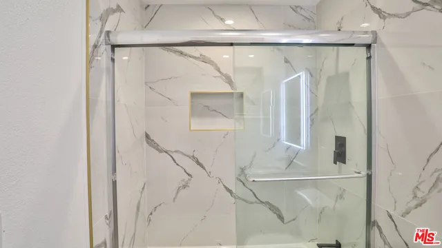 a view of a small space with wooden floor and a window