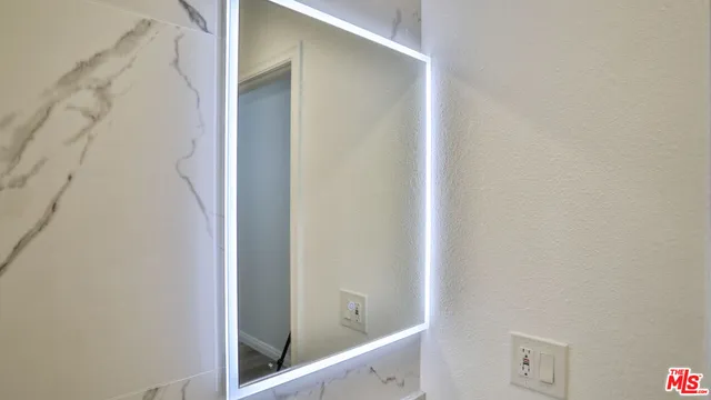 a kitchen with granite countertop a sink stove and cabinets