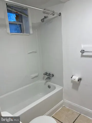 a bathroom with a bathtub and shower