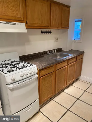 a kitchen with granite countertop cabinets washer and dryer