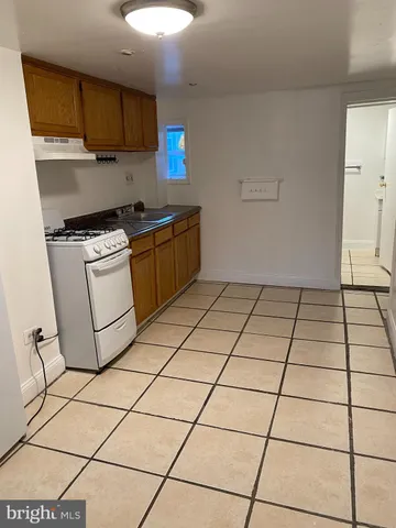 a kitchen with a stove a sink and a refrigerator