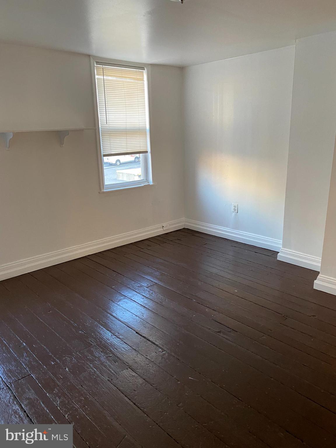 1012 South 12th Street, Unit 3 Philadelphia, PA 19147 - Photo 7 of 11 an empty room with wooden floor and windows