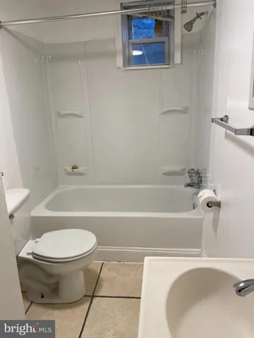 a bathroom with a sink a toilet and a bathtub