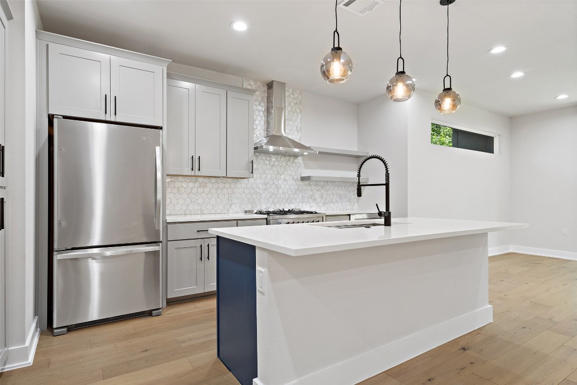 5109 Stone Gate Drive, Unit 2 Austin, TX 78721 - Photo 11 of 38 a kitchen with stainless steel appliances granite countertop a refrigerator a sink a stove a microwave and a refrigerator