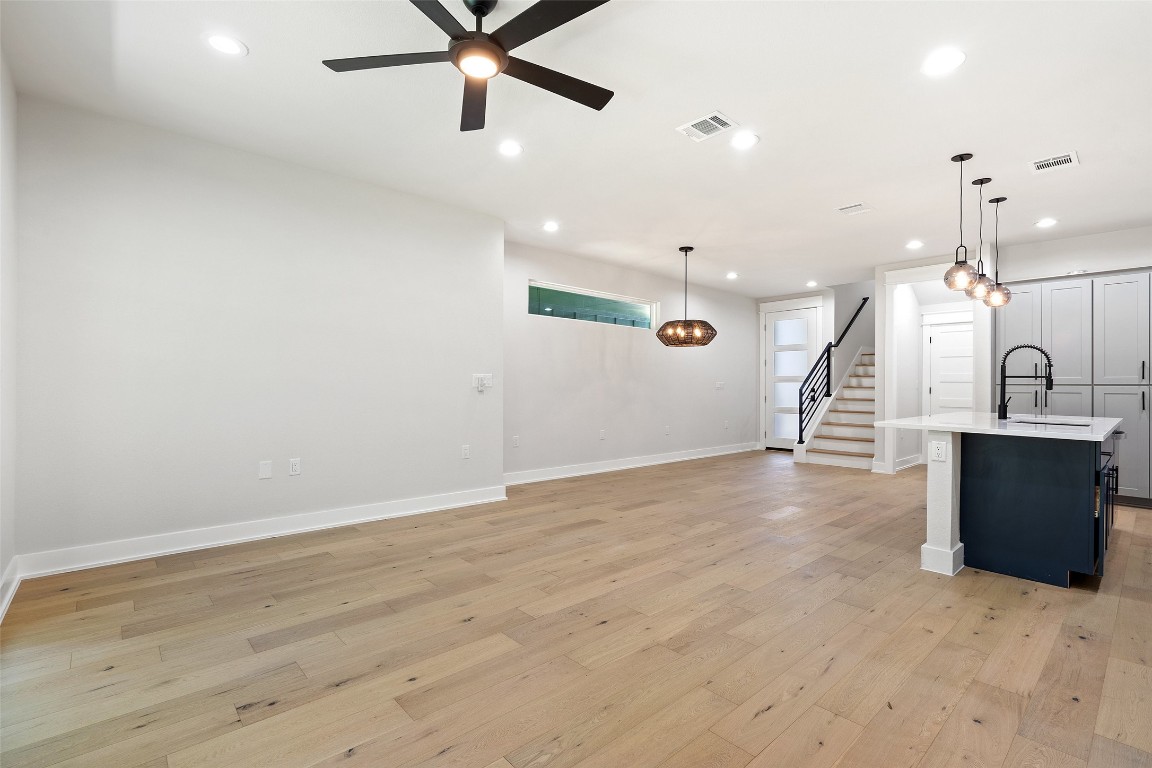 5109 Stone Gate Drive, Unit 2 Austin, TX 78721 - Photo 15 of 38 an empty room with wooden floor and a ceiling fan