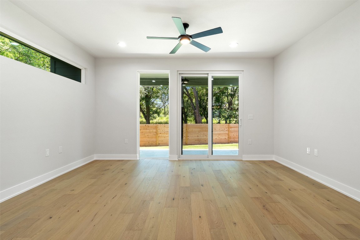 5109 Stone Gate Drive, Unit 2 Austin, TX 78721 - Photo 18 of 38 an empty room with wooden floor and windows