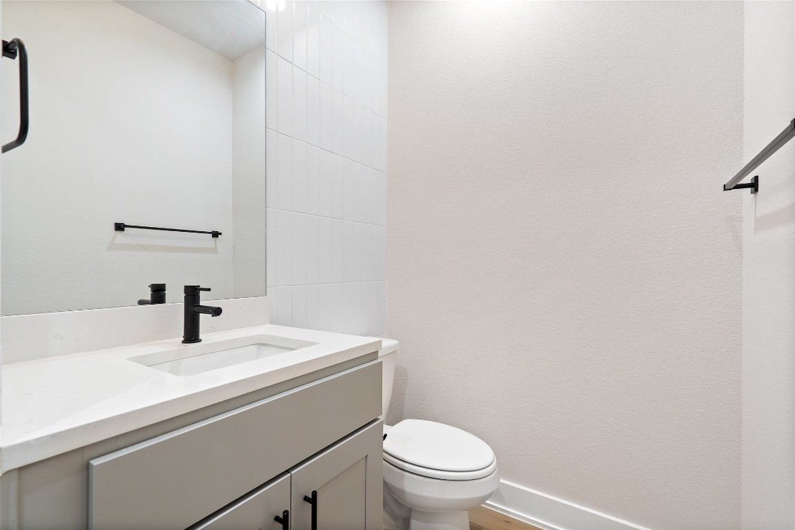 5109 Stone Gate Drive, Unit 2 Austin, TX 78721 - Photo 19 of 38 a bathroom with a sink a toilet and mirror