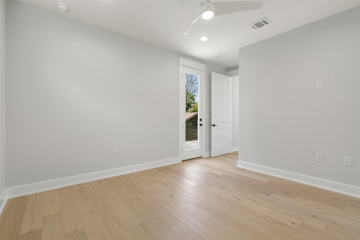 5109 Stone Gate Drive, Unit 2 Austin, TX 78721 - Photo 26 of 38 an empty room with wooden floor and closet
